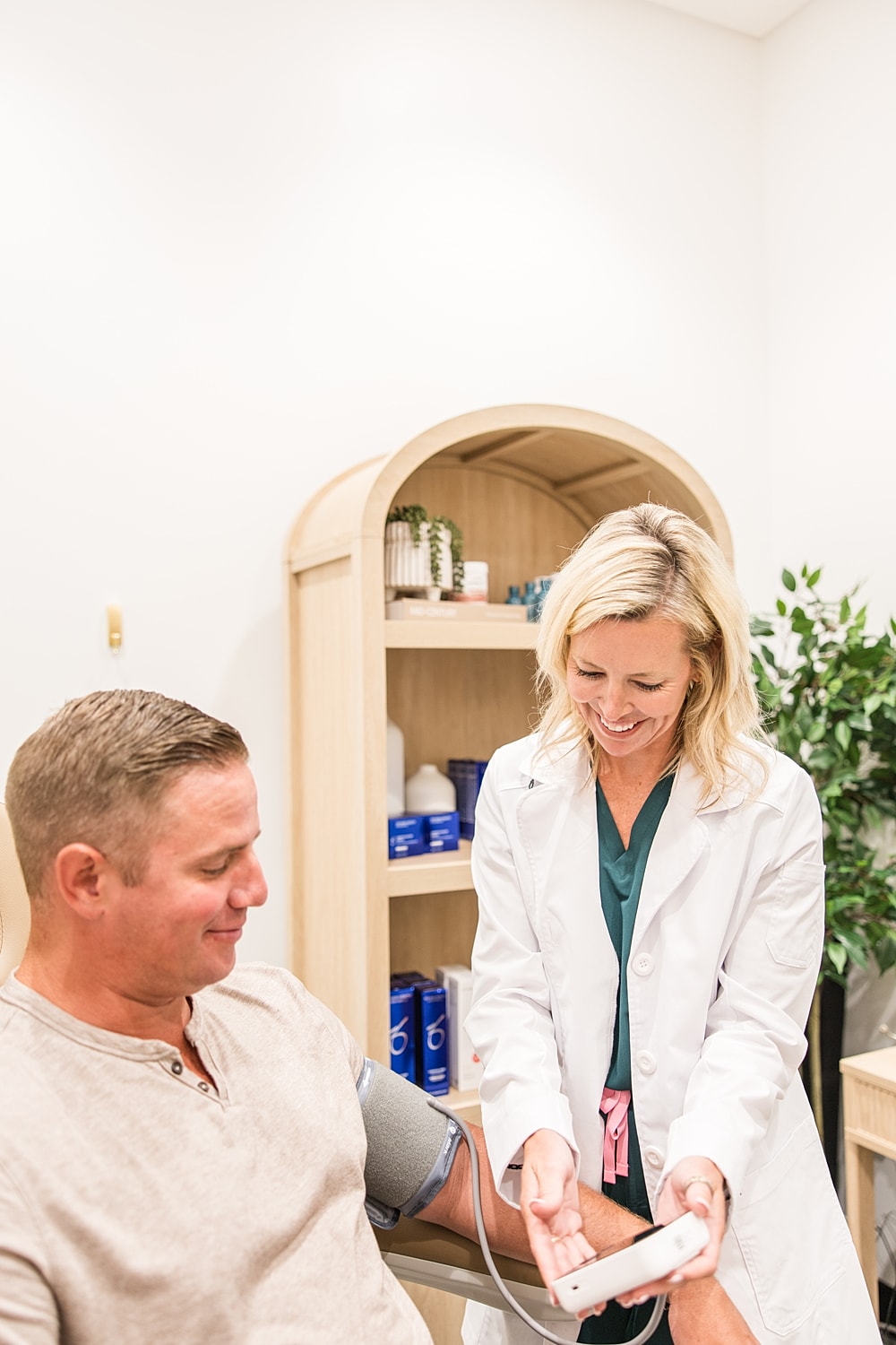 Healthcare professional taking patient’s blood pressure.