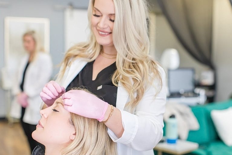 Client receiving beauty treatment in salon setting.
