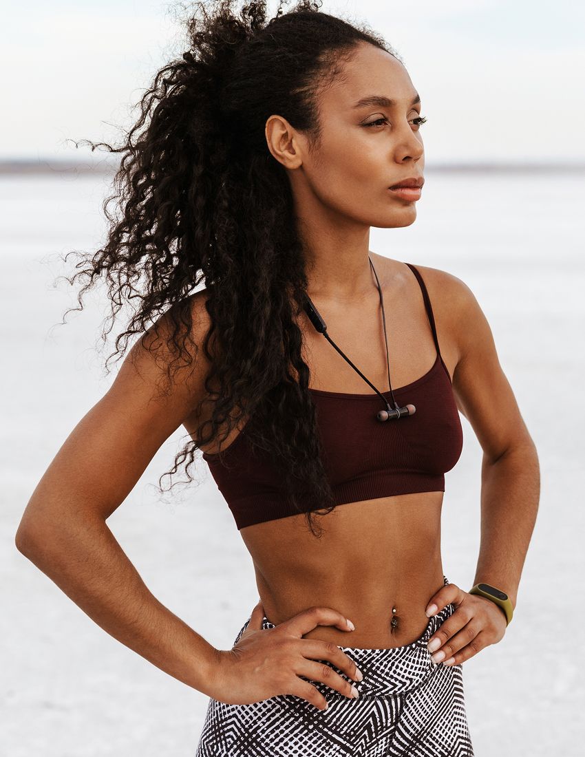 Athletic woman standing confidently outdoors.