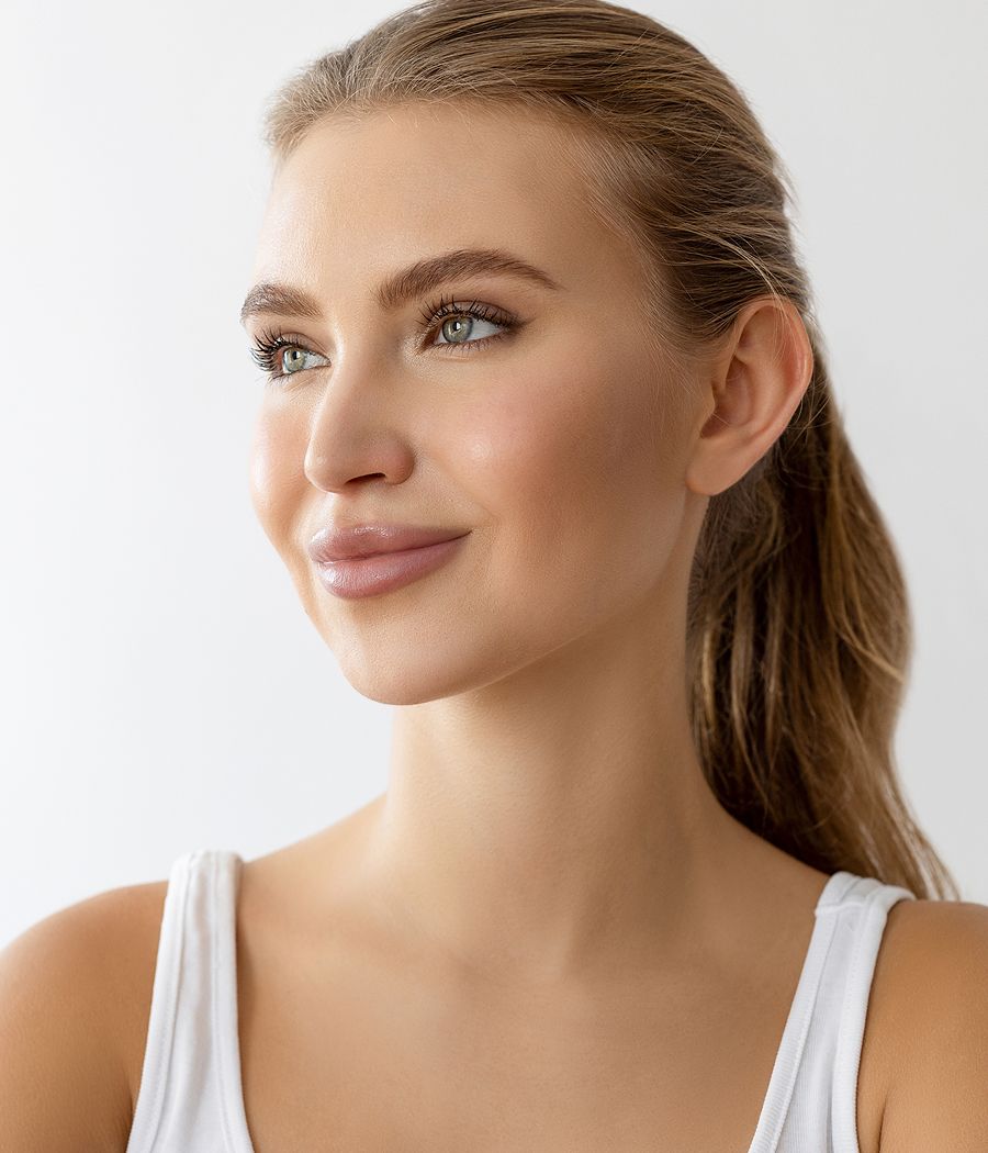 Woman with natural makeup and soft smile.
