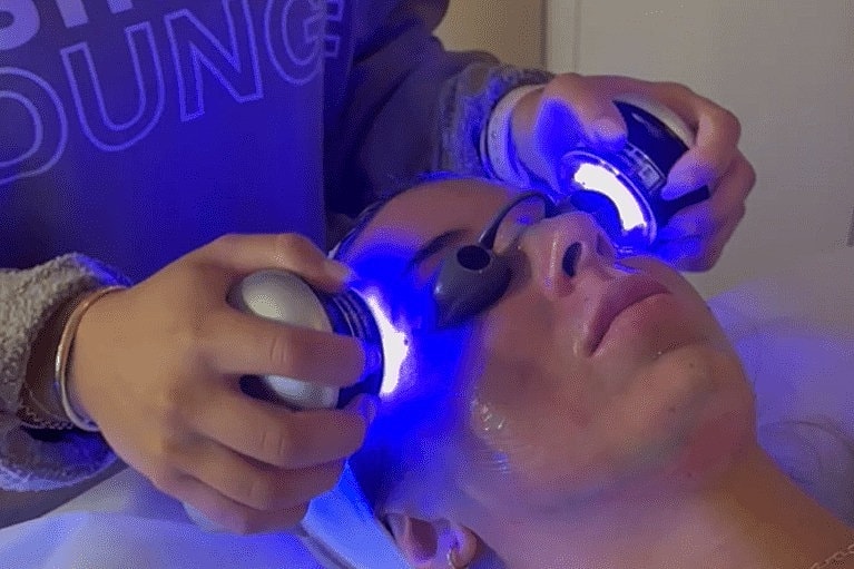 Facial treatment with blue light therapy devices.