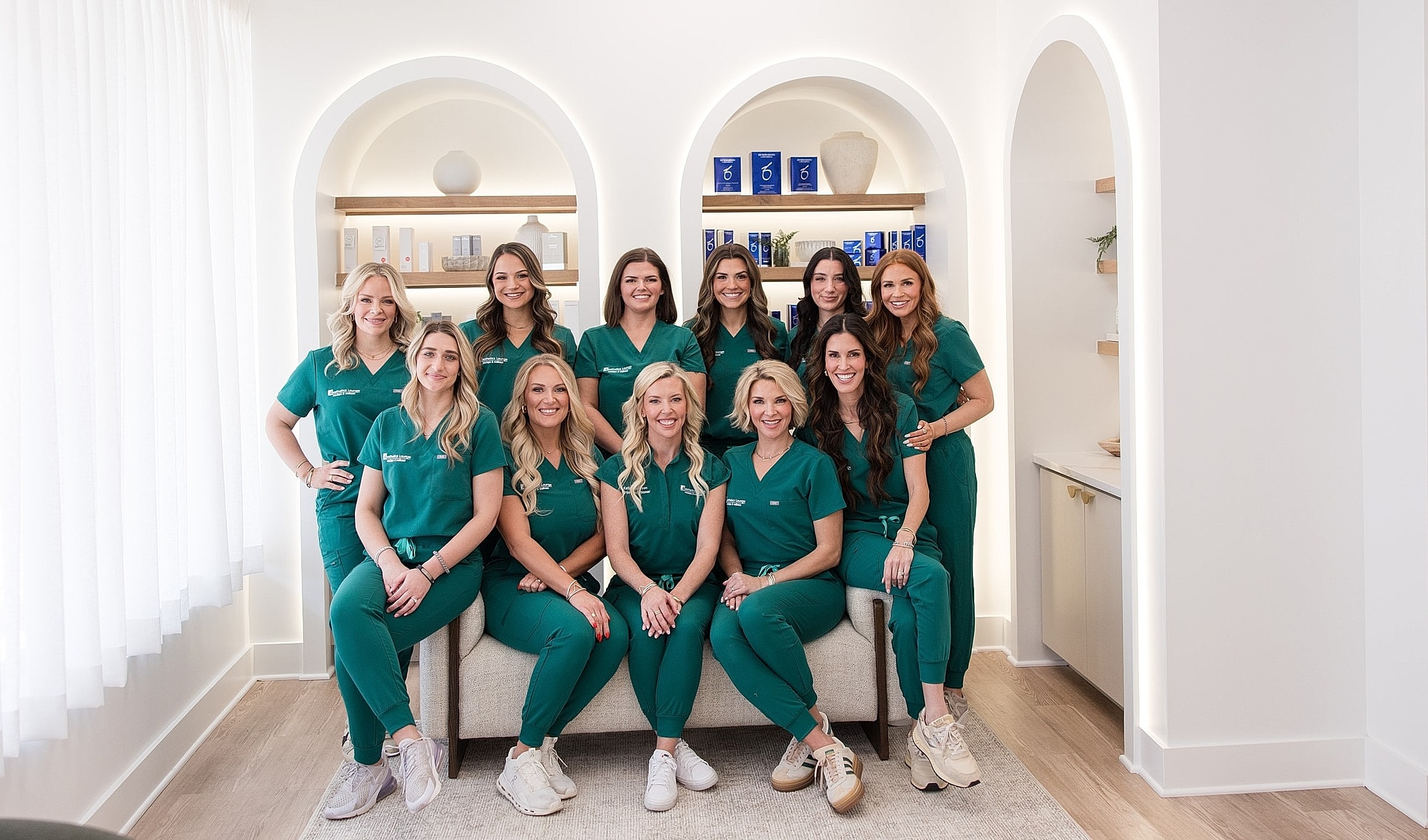 Team of professionals in green scrubs.