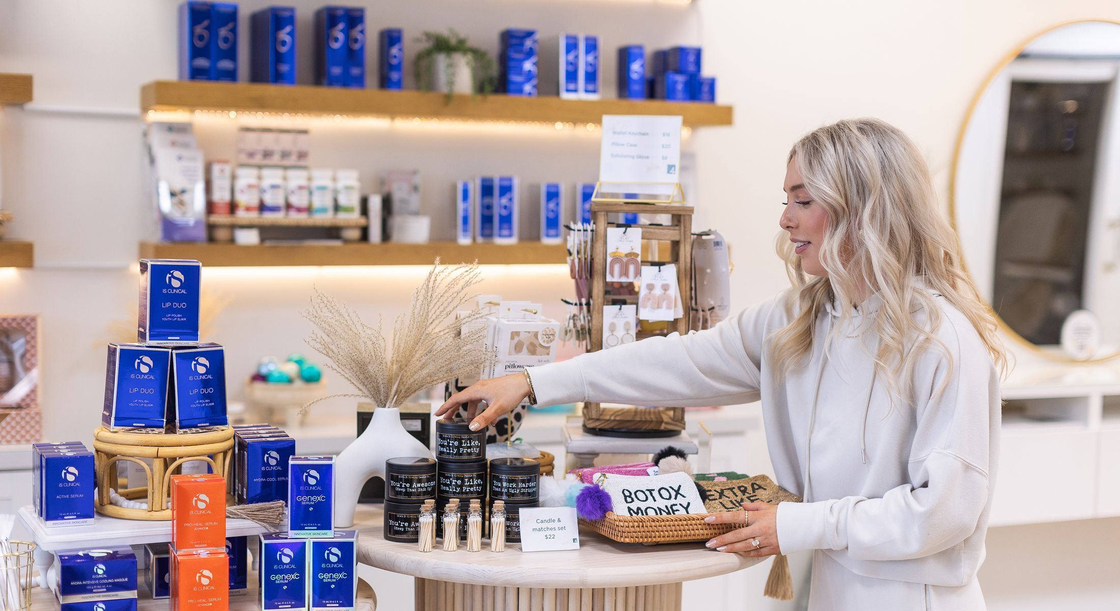 Woman organizing beauty products in a retail setting.