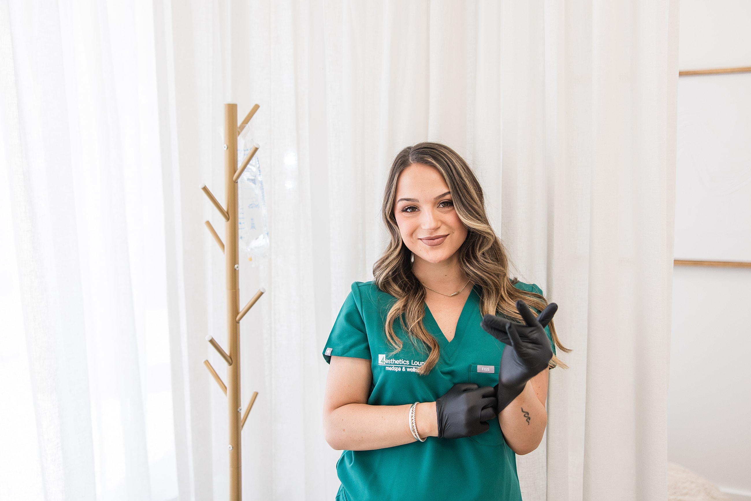 Woman in scrubs preparing for a procedure.