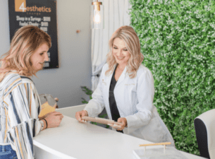 nurse practitioner at reception checking a patient in for Botox injections or Dysport or Xeomin treatments, hair restoration, prf treatments, and prp injections, hydrafacials